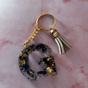 PORTE CLE G NOIR ET DOREE EN RESINE EPOXY